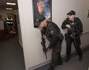 Ralph Marschhausen and Matthew Nolan, Security guards with the 23rd Space Operations Squadron, prepare to clear the 23rd SOPS command section office in Building 100 at New Boston Air Force Station, New Hampshire, April 10, 2018. Marschhausen and Nolan swiftly responded to the active shooter threat exercise scenario, conducted by the 50th Space Wing Inspector General's office during their inspection visit to the wing's geographically separated unit.