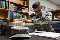 Airman Basic Jonathan, a 12th Training Squadron detail Airman, sorts through and checks a master list of military pilots and flight records April 18, 2018 at the Daedalian Foundation National Headquarters building on Joint Base San Antonio-Randolph, Texas.  Jonathan is referencing the master list with the original index cards that the Order of Daedalians has on file to make sure they comply with each other. (U.S. Air Force photo by Airman Shelby Pruitt) (Editor’s note: Only first names were given because the Air Force limits disclosure of identifying information to first names for all RPA pilots and sensor operators throughout their careers.)