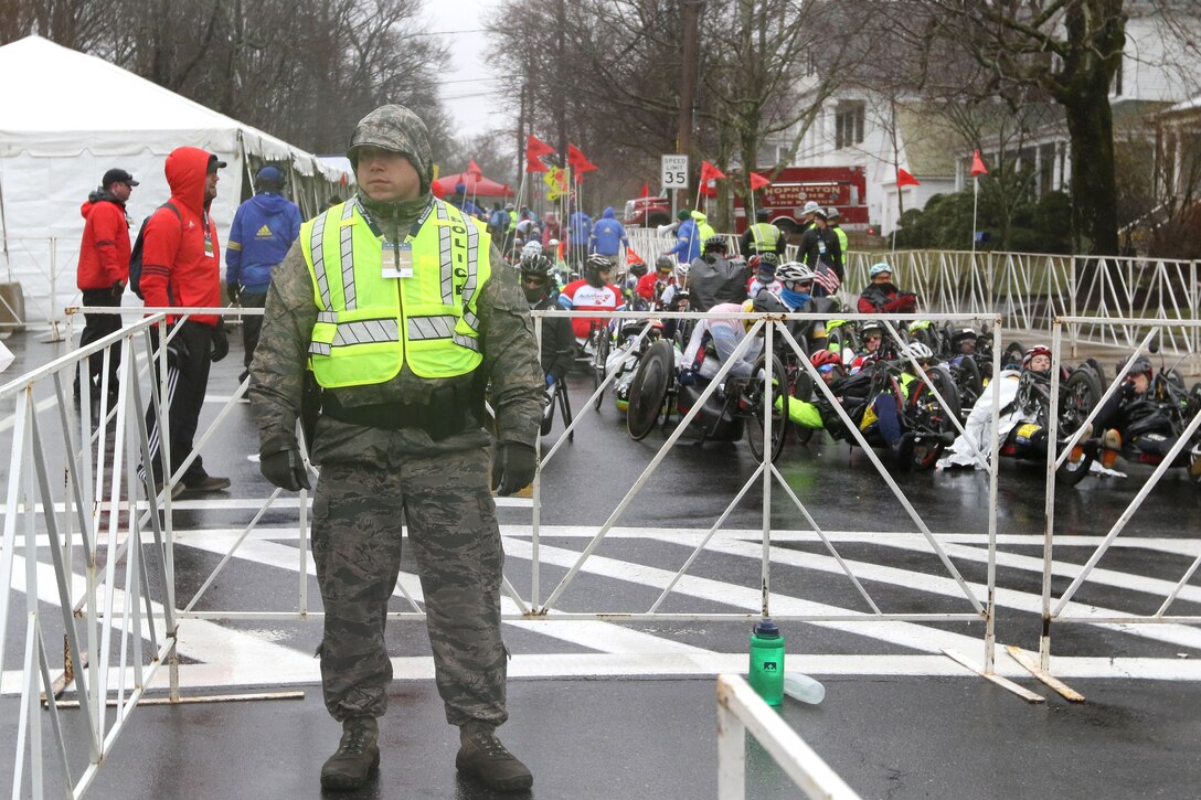 An airman provides security during the 122nd Boston Marathon.