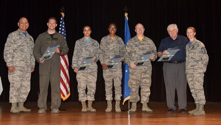 Col. Jimmy Canlas, left, 437th Airlift Wing commander, and Chief Master Sgt. Jennifer Kersey, right, 437th AW command chief, stand with 1st Quarter Award winners during a ceremony April 20, at Joint Base Charleston, S.C.