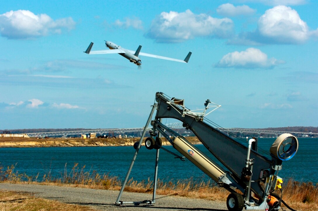 IMAGE: DAHLGREN, Va. - A Scan Eagle unmanned aerial vehicle launches from the Potomac River Test Range. Navy scientist Dr. Chris Weiland briefed visitors on the coordinated use of unmanned aerial vehicles for intelligence and targeting at a demonstration of Surface and Expeditionary Warfare Mission Module weapons at Naval Surface Warfare Center Dahlgren Division (NSWCDD), March 28. Navy scientists and engineers will integrate the mission module - comprising NSWCDD-developed engagement system technology and a Battle Management System - with Textron Systems' developmental Common Unmanned Surface Vehicle (CUSV). A cooperative research and development agreement between NSWCDD and Textron Systems covers the integration of missile, designator, and remote weapon station payloads to the developmental CUSV.   (U.S. Navy photo by John Williams/Released)