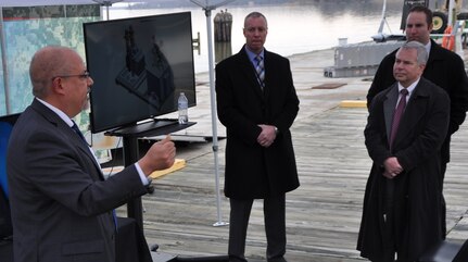 IMAGE: DAHLGREN, Va. (March 28, 2018) - John Fiore, Naval Surface Warfare Center Dahlgren Division (NSWCDD) technical director, addresses government, defense contractors and military personnel at a demonstration of NSWCDD-developed weapon technologies and Textron Systems' developmental Common Unmanned Surface Vehicle (CUSV). The autonomous Navy weapons systems - known as the Surface and Expeditionary Warfare Mission Module - are to be integrated as a proof of concept with the autonomous CUSV. “Our partnerships with industry allow us to move fast,” said Fiore. “If you’re the one that’s going to be giving this capability to warfighters, I want you to be effective in doing that. That’s what motivates us and that’s why we collaborate. That’s why it’s so important for us to have you here today with your equipment and have you partnering with us.” (U.S. Navy photo/Released)