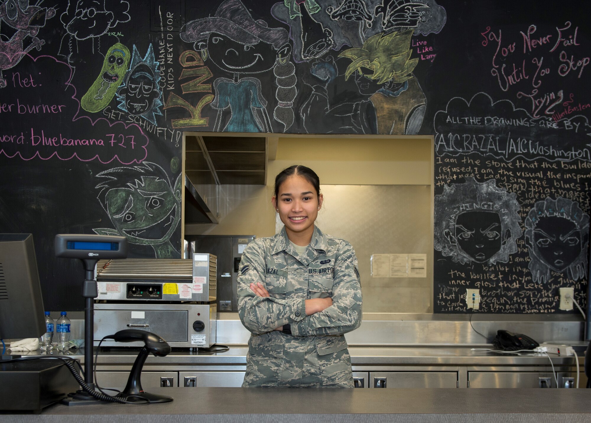 U.S. Air Force Airman 1st Class Marjoree Razal, 20th Force Support Squadron, food service apprentice stands behind a counter at the Afterburner Grill at Shaw Air Force Base, S.C., April 20, 2018.