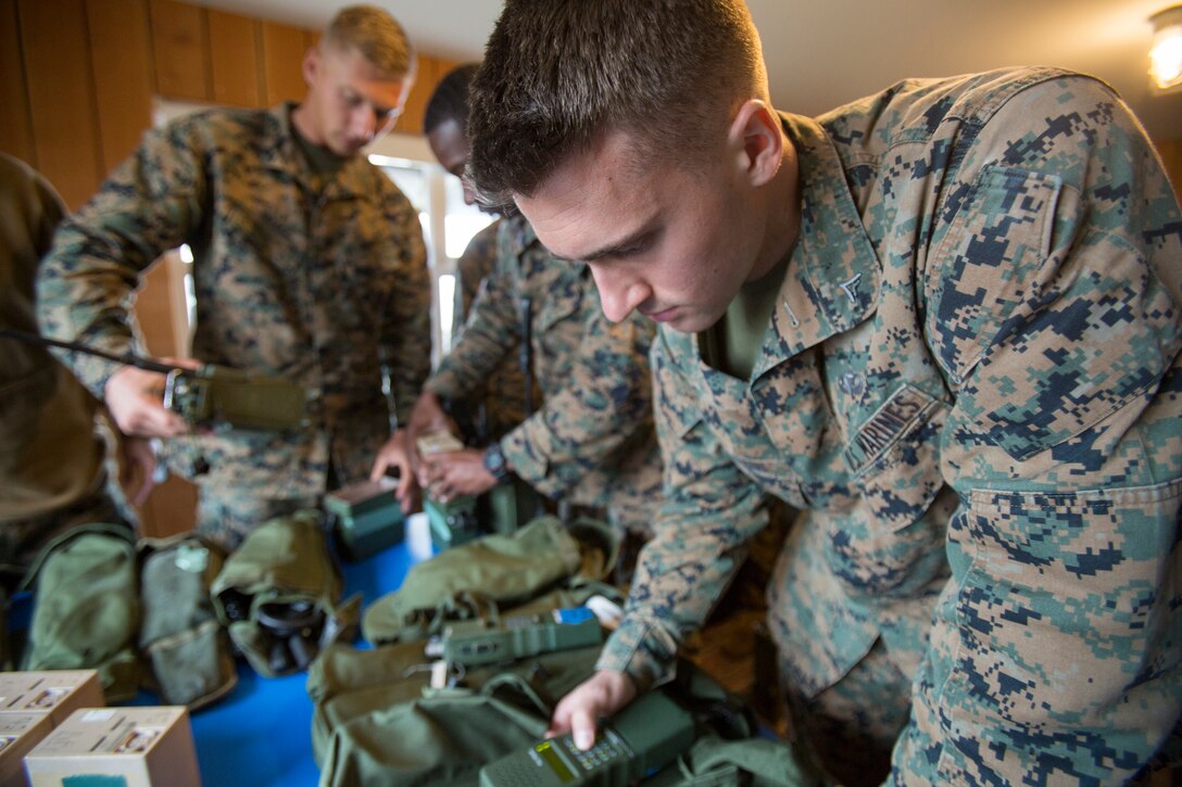 Lance Cpl. Wyatt Dillon, a radio operator with 4th Air Naval Gunfire Liaison Company, Force Headquarters Group, tests a radio as part of a gear accountability check, in Durness, Scotland, April 22, 2018.