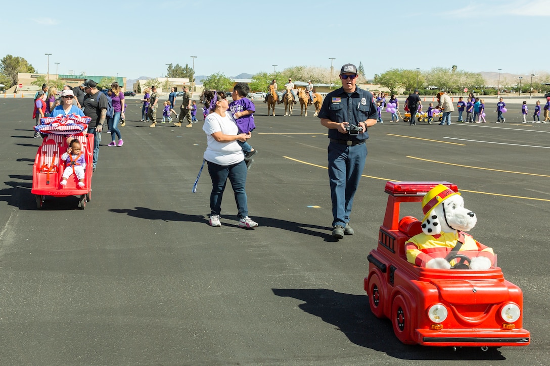Steve Nelson, MTD Specialist, operates Sparky, the symbol of fire prevention to children, during the Month of the Military Child Parade on Marine Corps Logistics Base Barstow, Calif., April 18.