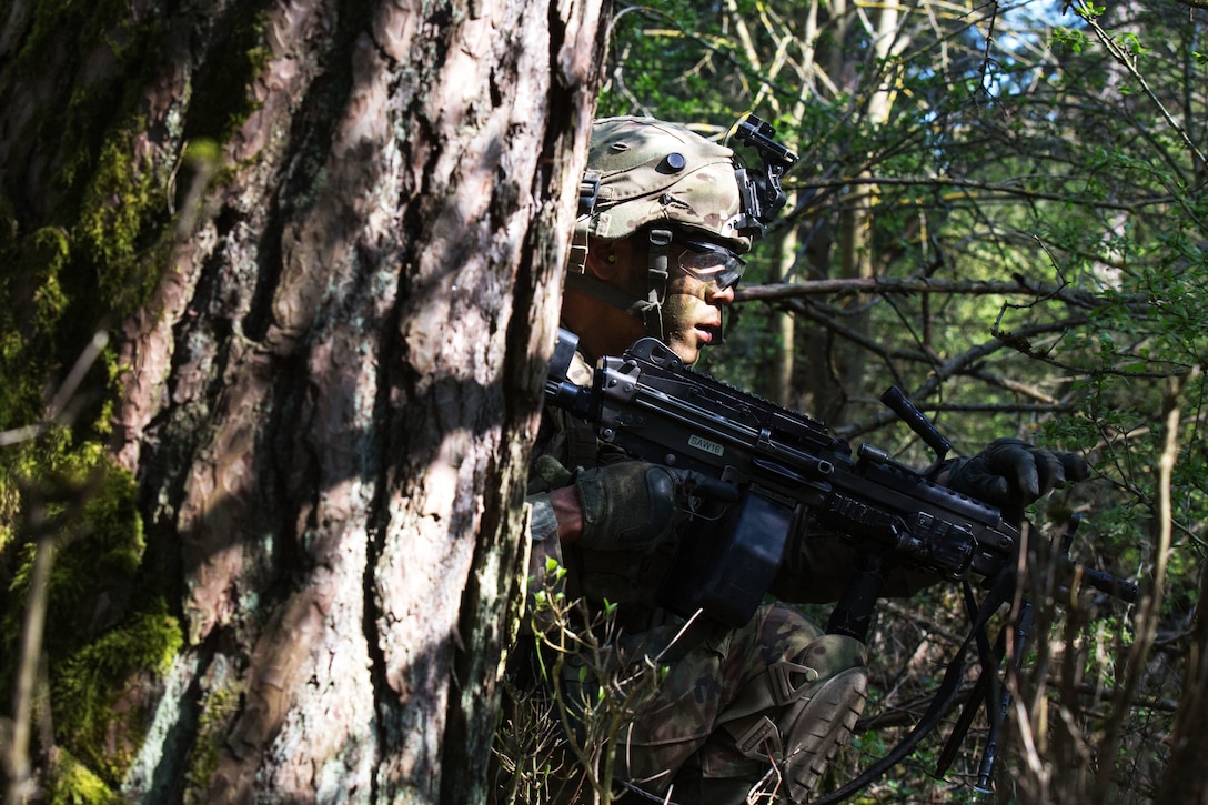 A soldier trains with an M249 squad automatic weapon.