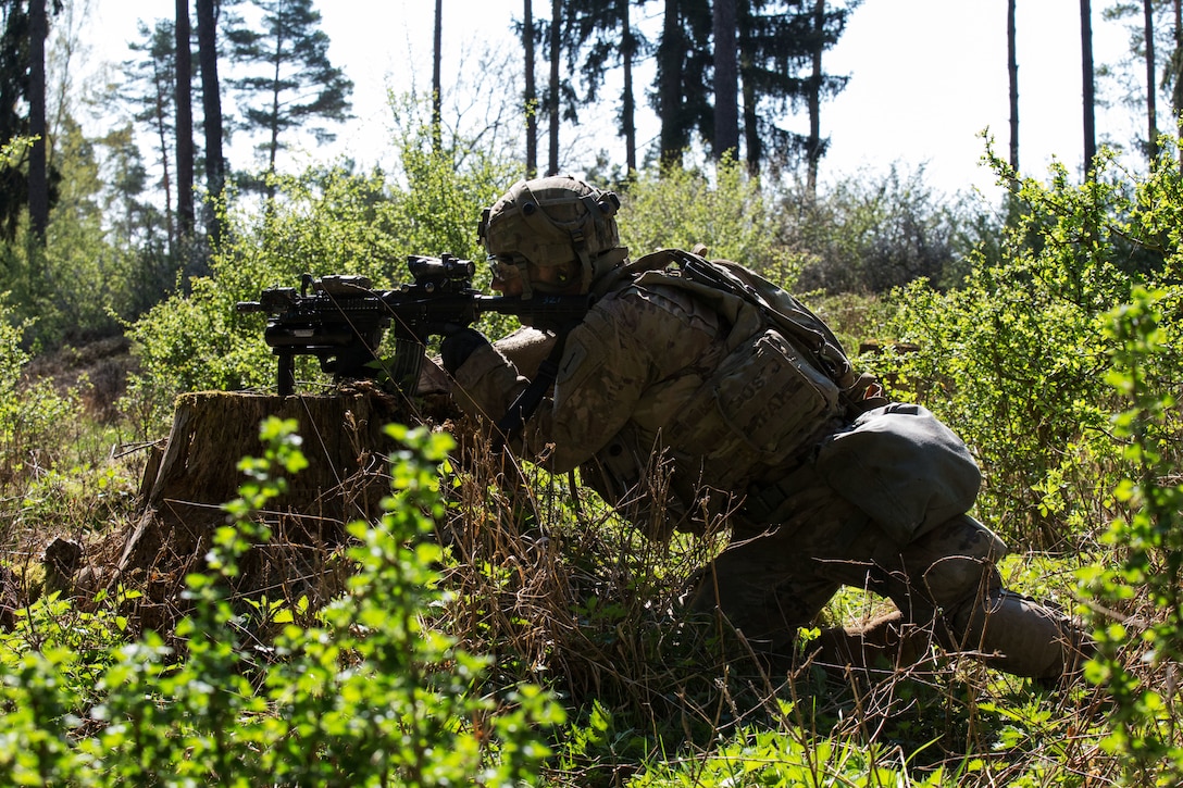 A soldiers uses an M203 grenade launcher.