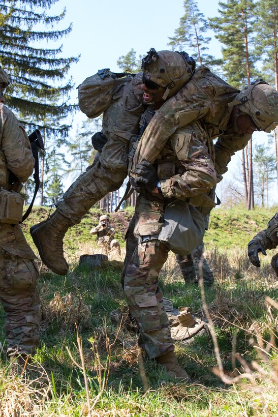 A soldier caries another soldier during the exercise.