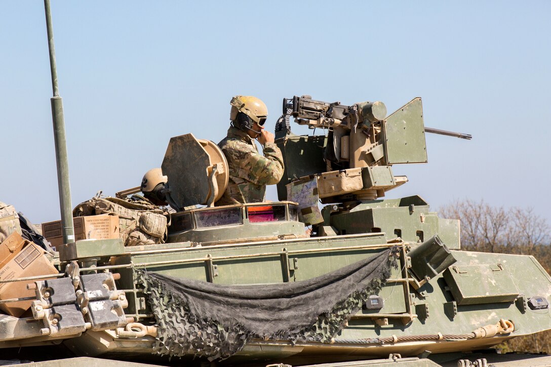 A tanker speaks in his headset for instructions.