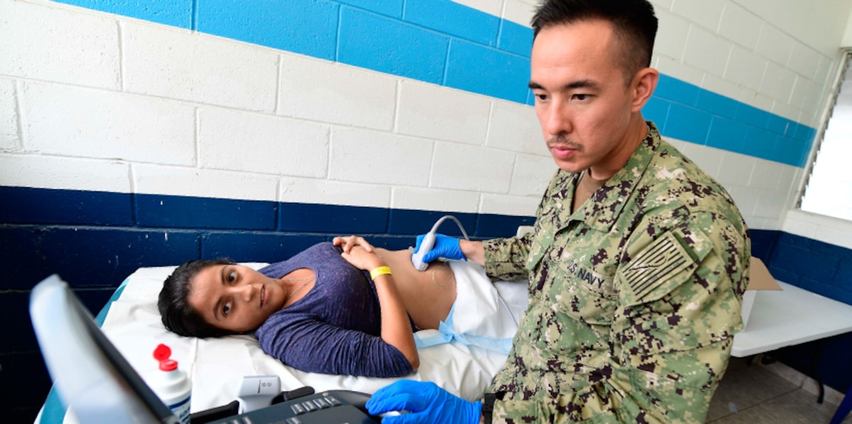 A Navy doctor performs an ultrasound for a pregnant Guatemalan woman.