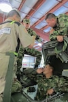 U.S. Army Sgt. Diego Franco translates from English to Spanish for Judson Hockman of General Dynamics Land Systems on M1135 Stryker maintenance during a State Partnership Program subject matter expert exchange April 18, 2018. Five soldiers from the Colombian army spent a week with Soldiers from the South Carolina Army National Guard during the exchange on maintenance best practices.