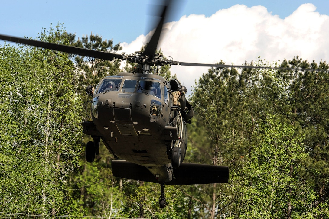 An Army UH-60 Black Hawk helicopter prepares to land.