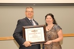 Dawn Leason, right, a Clothing and Textiles supervisory commodity business specialist, poses with Richard Ellis, left, DLA Troop Support deputy commander, during the Women’s History Month program April 11, 2018 at in Philadelphia.