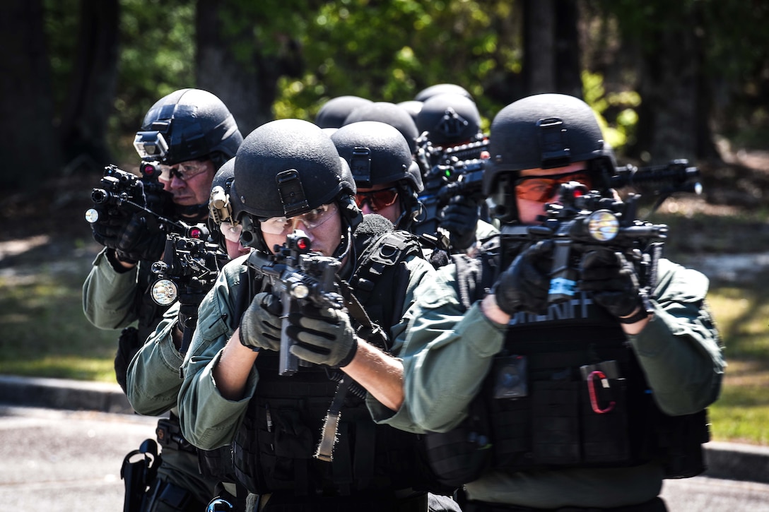 Civilian police maneuver in a tactical formation.