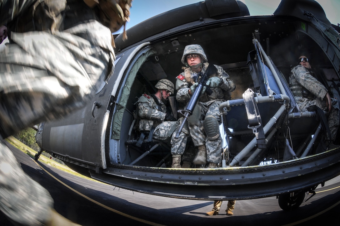 Cadets disembark an UH-60 Black Hawk helicopter.