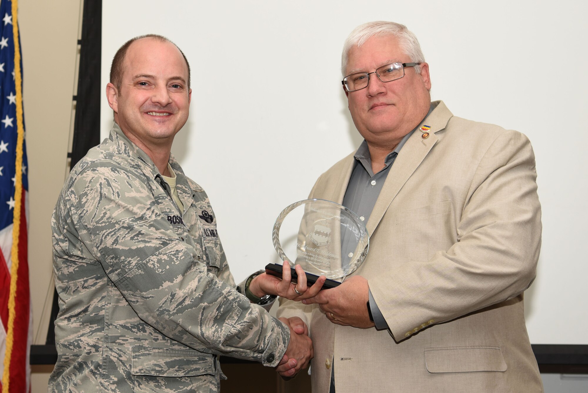 Edward Haldeman, 20th Fighter Wing (FW) Retirees Activities Office director, receives a Volunteer Excellence Award Nominee plaque from Col. John Bosone, 20th FW vice commander, during an annual volunteer recognition ceremony at Shaw Air Force Base, S.C., April 19, 2018.