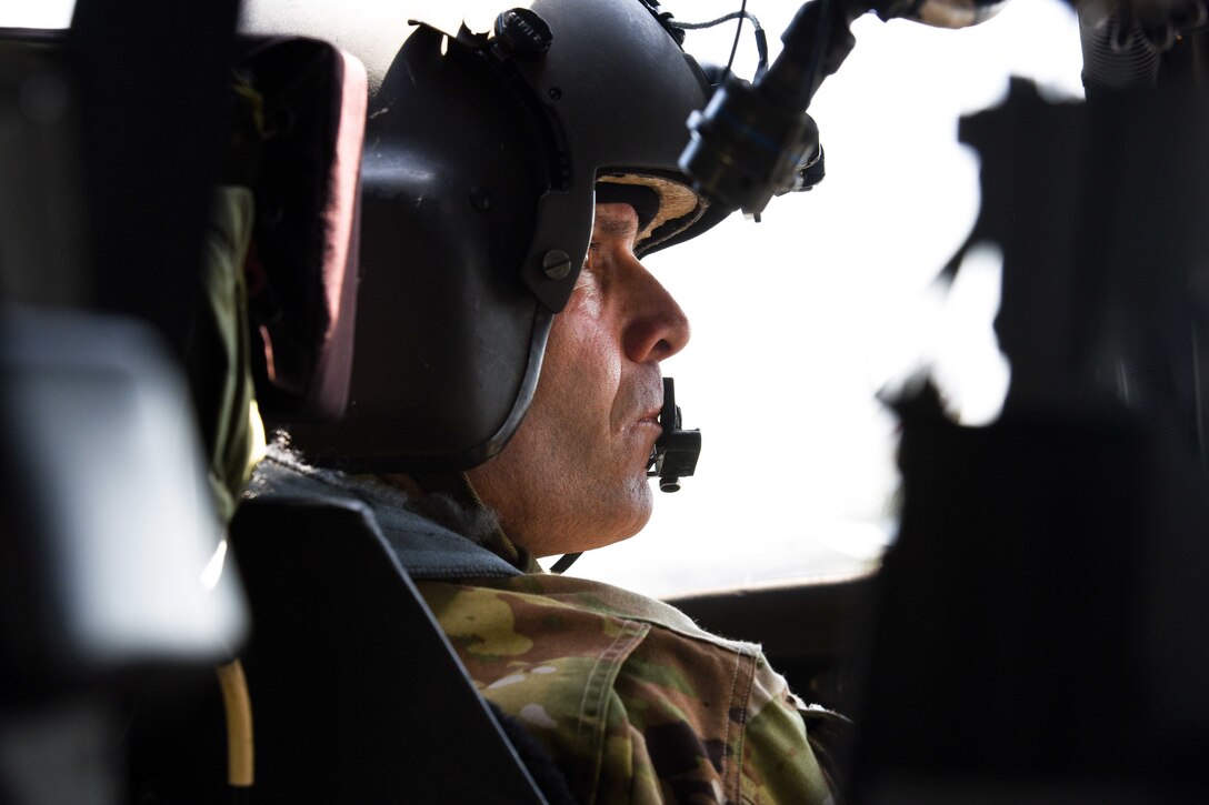 An Army pilot communicates with the crew chief.