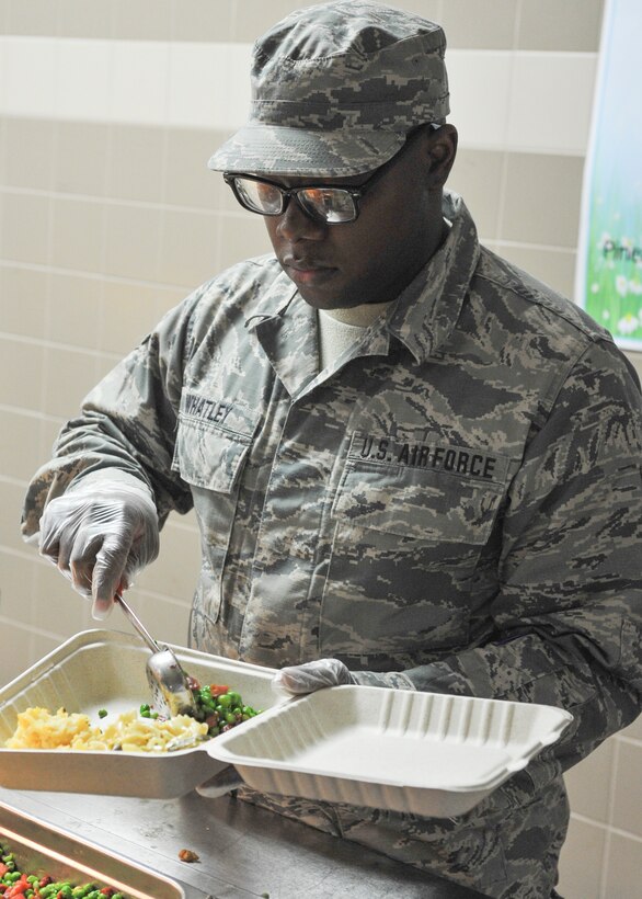 Airman Davonte Whatley, a server assigned to the 910th Force Support Squadron, serves food at the Community Activity Center on Youngstown Air Reserve Station April 8, 2018.