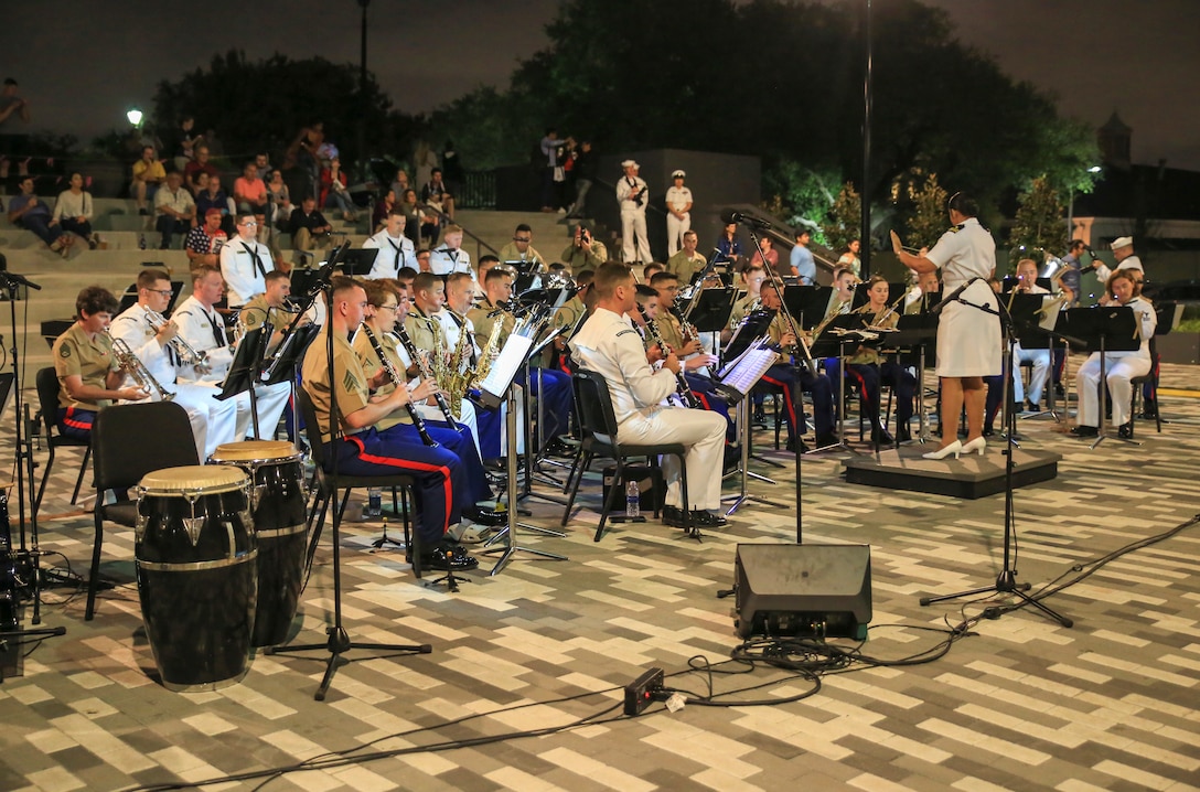 Marines with Marine Corps Band New Orleans accompanied by sailors from Navy Band Southeast out of Jacksonville, Florida, perform in the French Quarter in celebration of Navy Fleet week in New Orleans, April 21, 2018. The celebration is an opportunity for citizens of New Orleans and surrounding areas to meet service members and witness the latest capabilities of today’s maritime service. (U.S. Marine Corps photo by Lance Cpl. Samantha Schwoch/released)