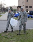 Staff Sgt. Nick Howard and Tech. Sgt. Travis Rowell, with the 552nd Air Control Network Squadron, teamed up to clean the grounds around the 552nd Air Control Wing during Tinker Pride Day Apr. 13, 2018.