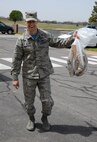 72nd Mission Support Group Commander Col. Mark Vitantonio shows off his bag of trash he picked up from the area around the 72nd Air Base Wing.