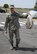 72nd Mission Support Group Commander Col. Mark Vitantonio shows off his bag of trash he picked up from the area around the 72nd Air Base Wing.