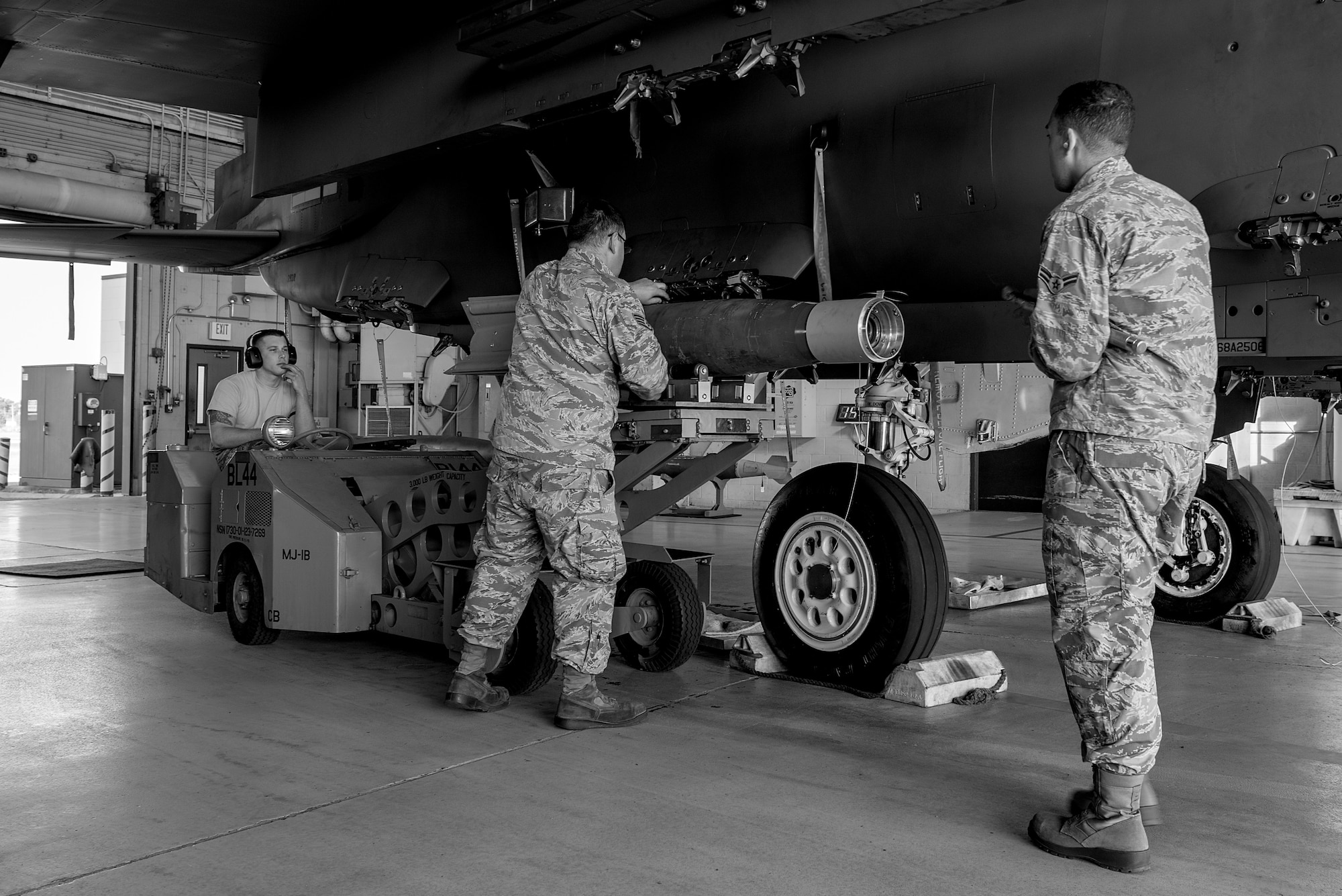 Airman 1st Class Kyle Shaw (left), Staff Sgt. Casey Chilcote, and Airman 1st Class Dylan Davis, 4th Aircraft Maintenance Squadron load crew members, load a training weapon onto an F-15E Strike Eagle, April 20, 2018, at Seymour Johnson Air Force Base, North Carolina.