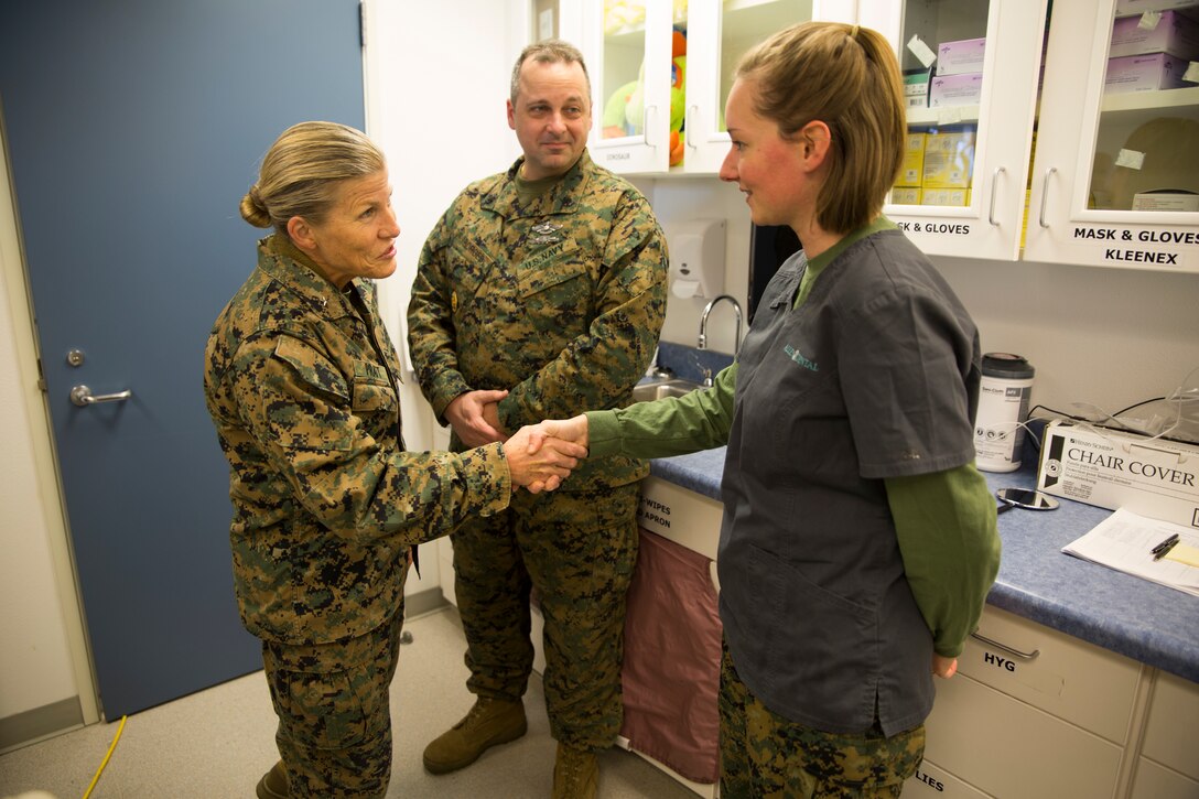 Brig. Gen. Helen G. Pratt, left, commanding general of 4th Marine Logistics Group, presents Seaman Apprentice Tiffany J. Parker, a dental assistant with 4th Dental Battalion, with a challenge coin to congratulate her on going above and beyond during Innovative Readiness Training Arctic Care 2018, Noatak, Alaska, April 21, 2018.