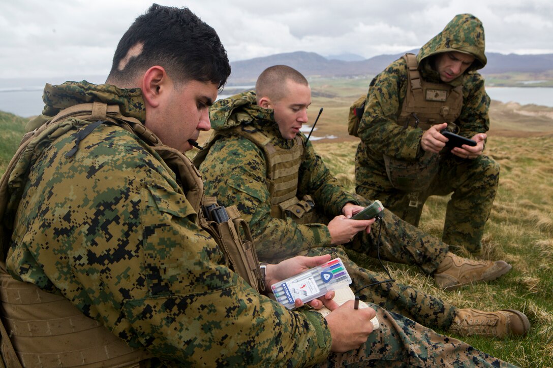 (Left to right) David Rodriguez, a forward observer with 4th Air Naval Gunfire Liaison Company, Force Headquarters Group, and Sgt.'s Andrew Snow and Michael Peers, both firepower control team chiefs with 4th ANGLICO, FHG, discuss and plot coordinates during a practice call-for-fire in Durness, Scotland, April 22, 2018.