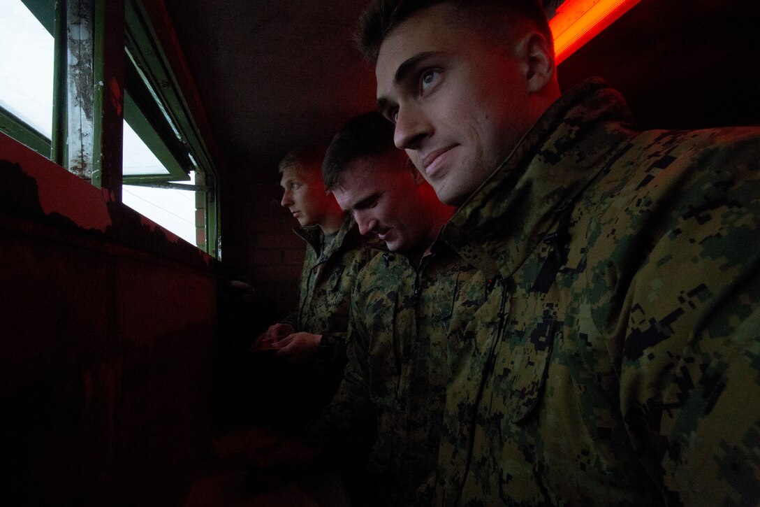 (right to left) Lance Cpl. Wyatt Dillon, radio operator with 4th Air Naval Gunfire Liaison Company, Force Headquarters Group, Lance Cpl. Dalton Vandervoort, a forward Observer with 4th ANGLICO, FHG, and Lance Cpl. Randolph Bragg, a radio operator with 4th ANGLICO, FHG, look out to a possible impact location during a practice call-for-fires drill, in Durness, Scotland, April 22, 2018.