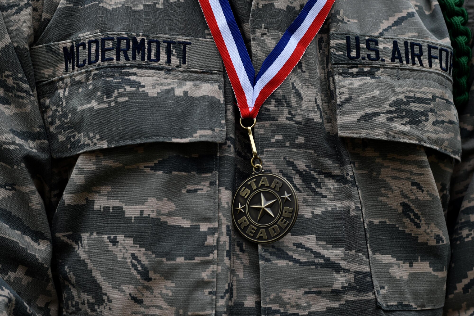 U.S. Air Force Airman Connor McDermott, 316th Training Squadron trainee, stands with a Star Reader medallion given to him during Read to Me at the San Angelo courthouse in San Angelo, Texas, April 20, 2018. Each veteran at the event received a Star Reader medallion as a thank you for their service. (U.S. Air Force photo by Senior Airman Randall Moose/Released)