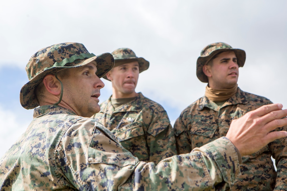 Capt. Schuyler Newsom, the supporting arms liaison team leader with 4th Air Naval Gunfire Liaison Company, Force Headquarters Group, talks about observational post locations and avenues to properly approach them, in Cape Wrath, Scotland, April 23, 2018.