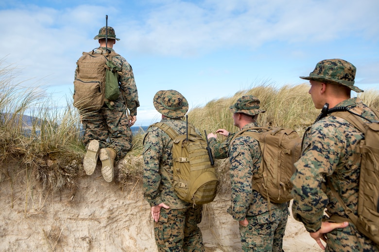 Lance Cpl. Wyatt Dillon (left), radio operator with 4th Air Naval Gunfire Liaison Company, Force Headquarters Group, along with other 4th ANGLICO Marines, look for possible observation posts during a hike to Cape Wrath, Scotland, April 23, 2018.