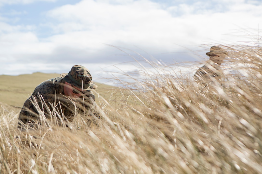 Sgt. Michael Kozik, a firepower control team chief with 4th Air Naval Gunfire Liaison Company, Force Headquarters Group, unpacks his gear before establishing an observation post, in Cape Wrath, Scotland, April 23, 2018.