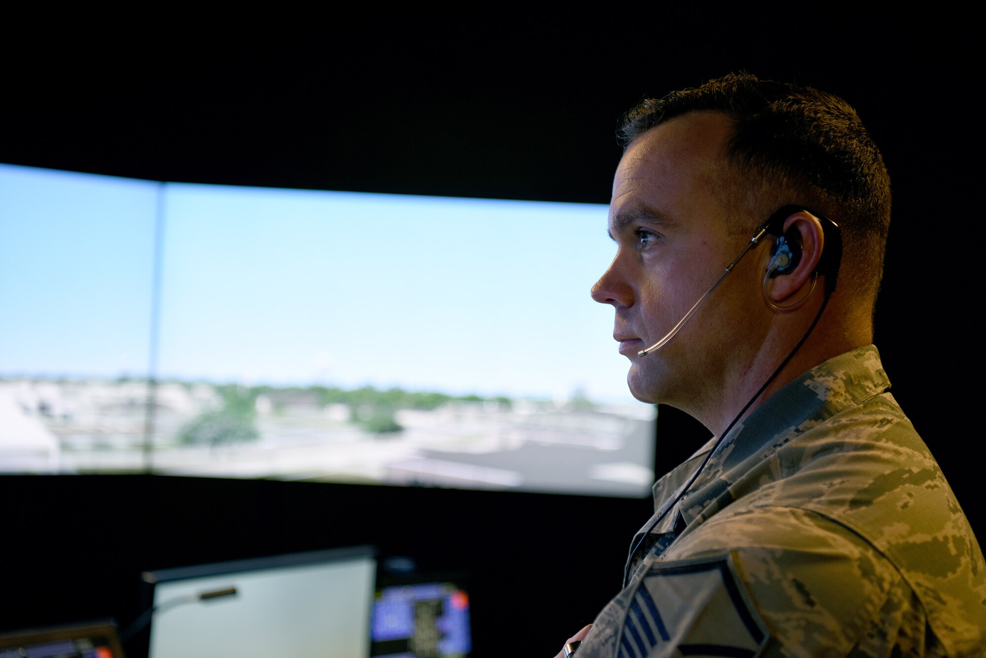 U.S. Air Force Master Sgt. Brian Cloutier, 81st Training Wing protocol NCO in charge, looks at a simulated runway in the air traffic control tower simulator at Keesler Air Force Base, Mississippi, March 28, 2018. Cloutier, a former air traffic controller of 13 years, has been recently selected to become a remotely piloted aircraft pilot. (U.S. Air Force photo by Airman 1st Class Suzie Plotnikov)