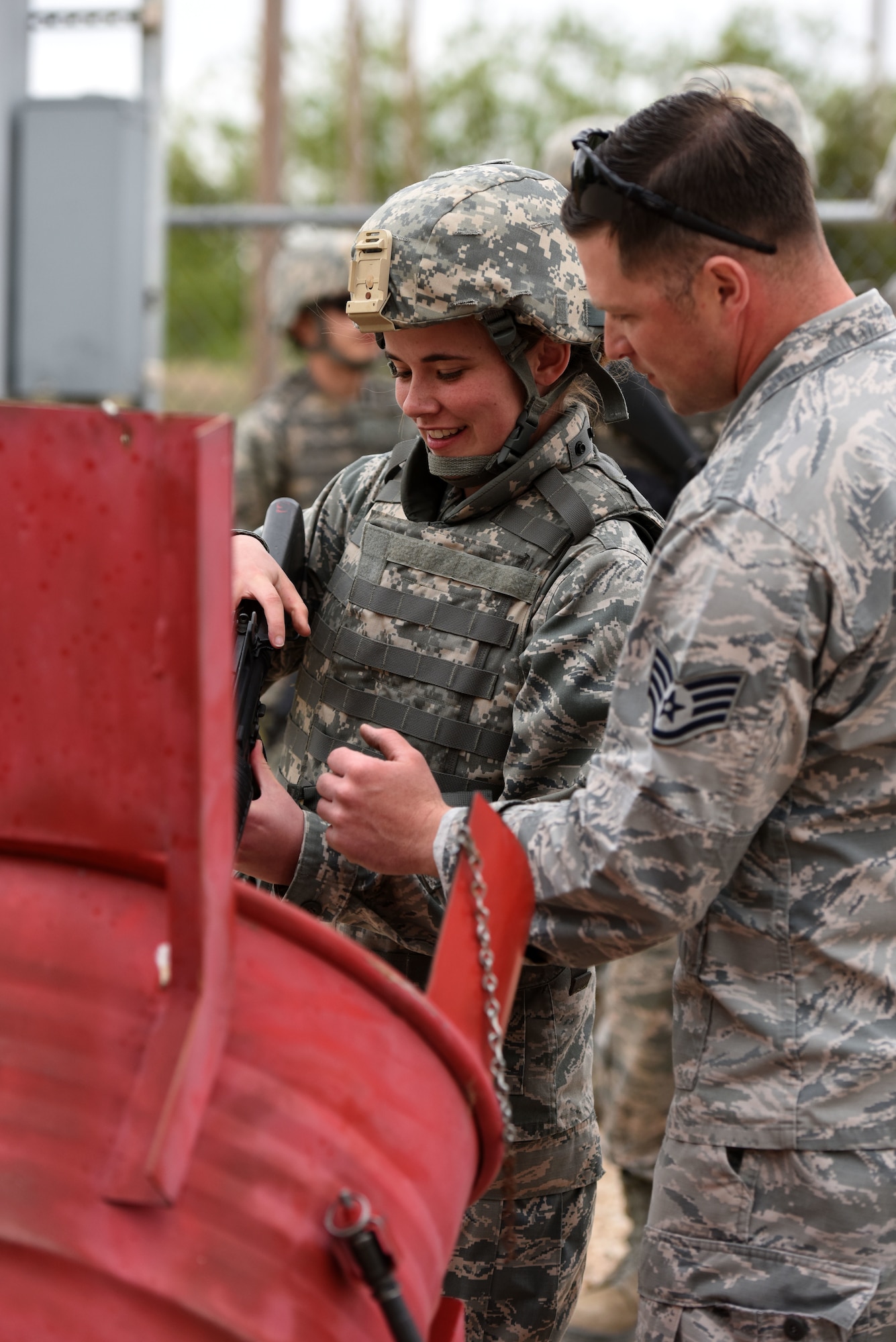 U.S. Air Force Staff Sgt. Zachary Whitman, 17th Security Forces Squadron unit trainer, demonstrates to Mikalya Strikland, Angelo State University Air Force ROTC cadet, how to clear her weapon at the mock forward operating base on Goodfellow Air Force Base, Texas, April 20, 2018. The cadets participated in training lasting through the night and into the next day. (U.S. Air Force photo by Airman 1st Class Seraiah Hines/Released)