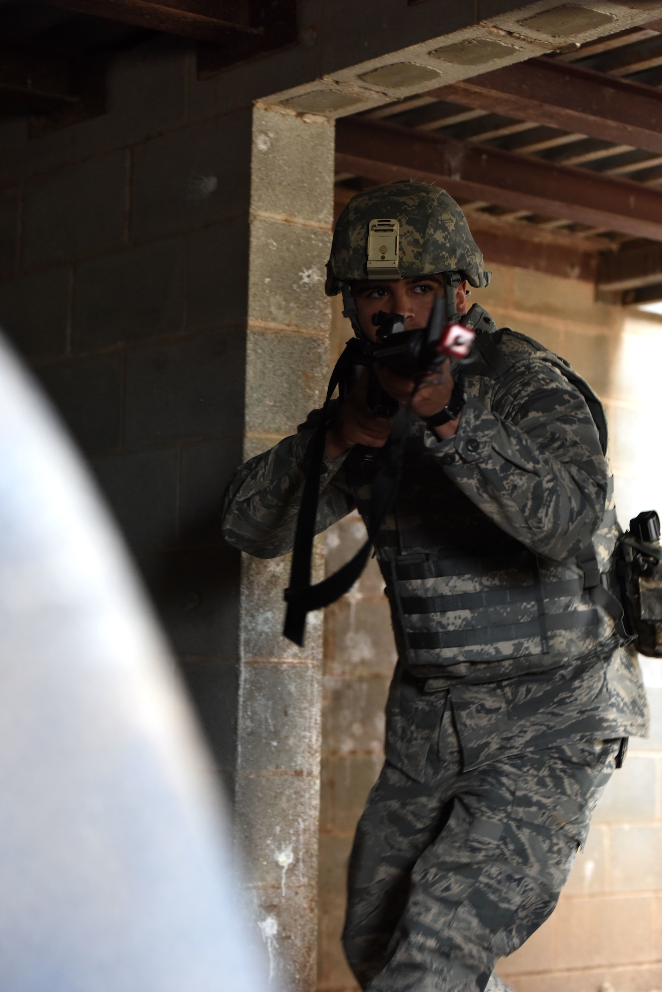Andrew Burrola, Angelo State University Air Force ROTC cadet, practices room clearing techniques during a training exercise at the mock forward operating base on Goodfellow Air Force Base, Texas, April 20, 2018. The cadets had to use the skills learned during the training exercise when accomplishing a variety of scenarios presented by instructors and cadres. (U.S. Air Force photo by Airman 1st Class Seraiah Hines/Released)
