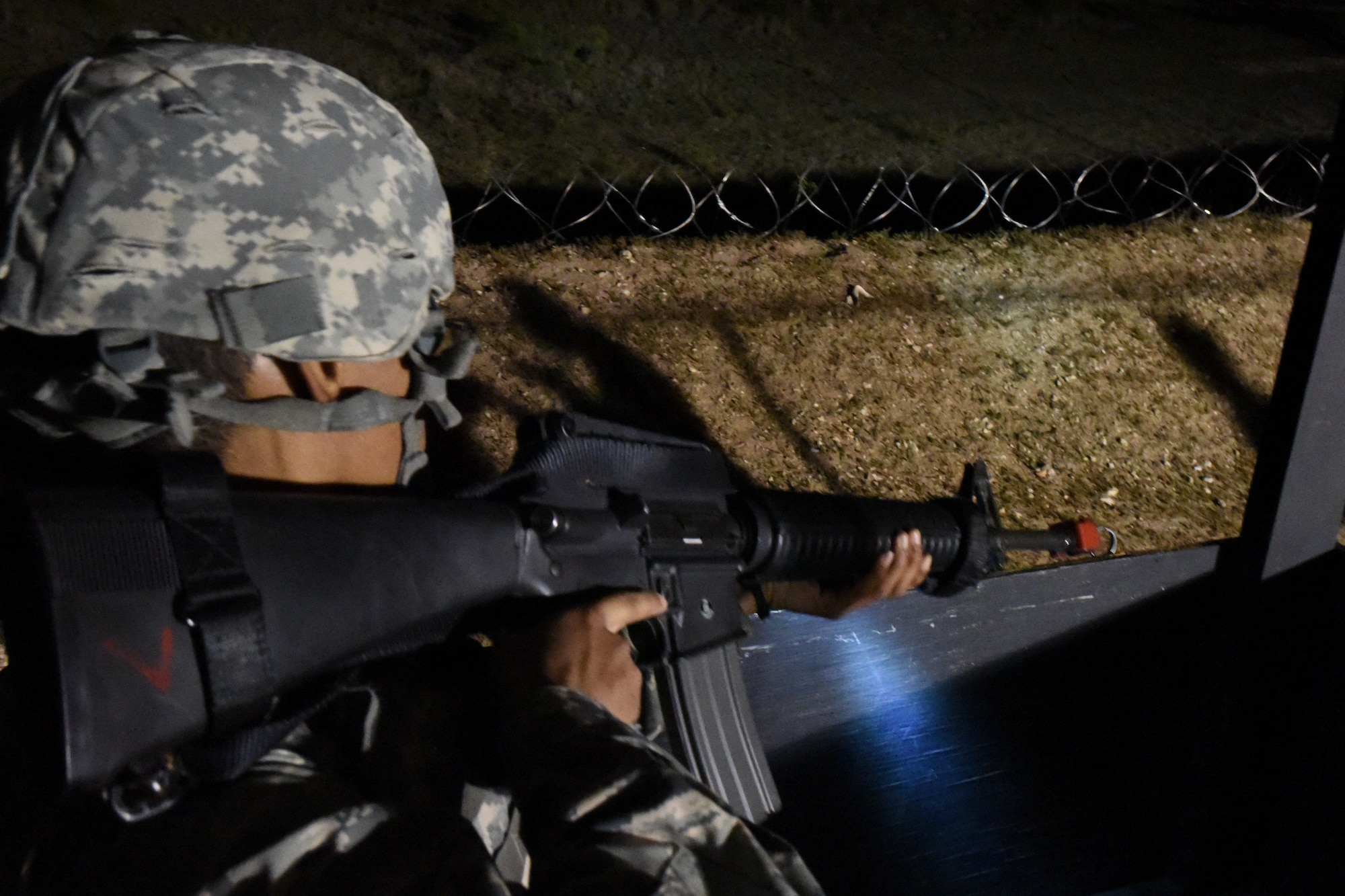 Williams Joseph, Angelo State University ROTC cadet, practices guard tower maneuvers during the night operations portion of the exercise at the mock forward operating base on Goodfellow Air Force Base, Texas, April 20, 2018. The cadets had multiple permanent party members acting as opposition forces testing their training throughout the night. (U.S. Air Force photo by Airman 1st Class Seraiah Hines/Released)