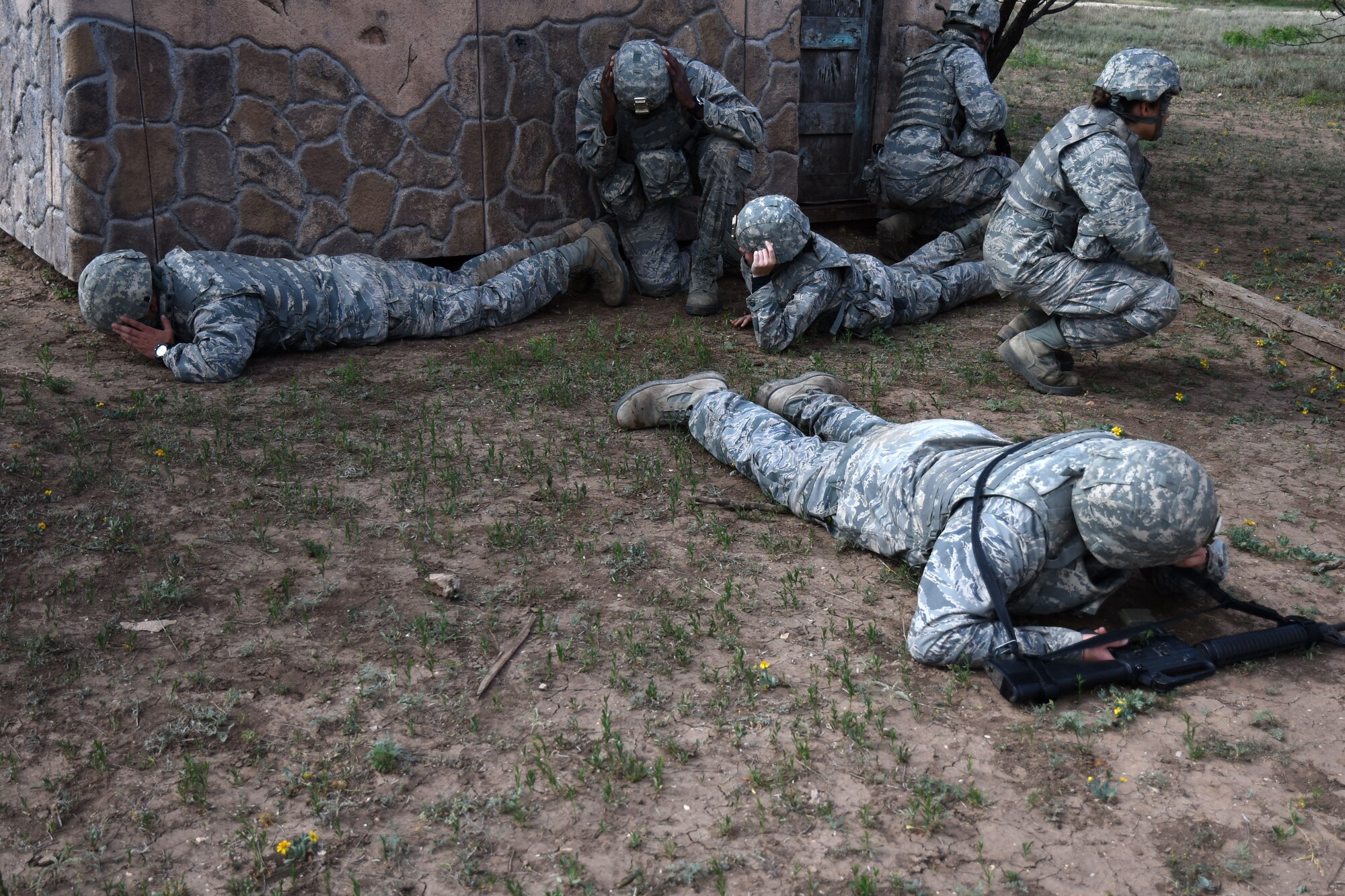 Angelo State University Air Force ROTC cadets go prone after hearing a simulated bomb go off at the mock forward operating base on Goodfellow Air Force Base, Texas, April 21, 2018. The cadets participated in exercises which involved using leadership skills to properly execute a variety of missions. (U.S. Air Force photo by Airman 1st Class Seraiah Hines/Released)