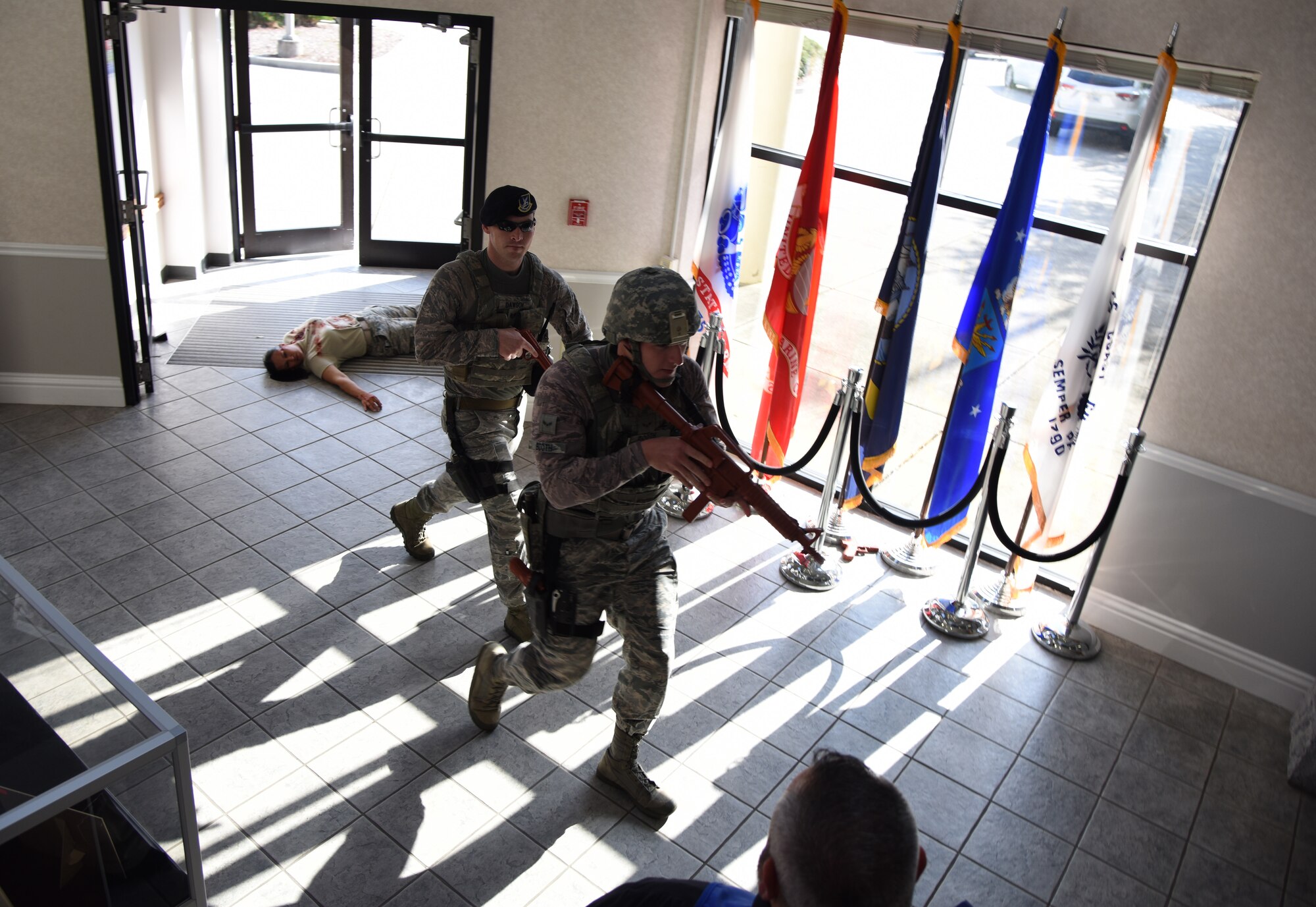 U.S. Air Force Staff Sgt. Timothy Dawson, 81st Security Forces Squadron military working dog handler, left, and Airman 1st Class Michael Booth, 81st SFS installation entry controller, enter the Levitow Training Support Facility during an active shooter exercise at Keesler Air Force Base, Mississippi, April 19, 2018. The wing inspection team had an active duty Air Force member simulate opening fire at the facility in order to test the base’s ability to respond and recover from a mass casualty event. (U.S. Air Force photo by Kemberly Groue)
