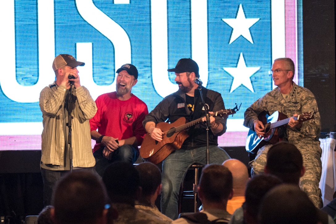 Air Force Gen. Paul J. Selva, vice chairman of the Joint Chiefs of Staff, and the musicians play a song on stage.