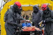 Soldiers from 3rd platoon, 22nd Engineer Clearance Company, decontaminate a casualty during Guardian Response 18 at Muscatatuck Urban Training Center, Indiana on April 22, 2018. The decontamination process includes striping the casualty down, washing them, wrapping them in a blanket, and then monitoring them. U.S. Army North executes the annual Vibrant Response consequence management exercise at the direction of U.S. Northern Command to confirm command and control elements of the nation’s CBRN response forces. U.S. Force Command’s linked exercise, Guardian Response, held at Muscatatuck Urban Training Center, validates how the subordinate units train to carry out the operations under the direction of a joint task force. GR18 is executed by the U.S. Army Reserve Command. (U.S. Army National Guard photo by Cpl. Elizabeth Scott)