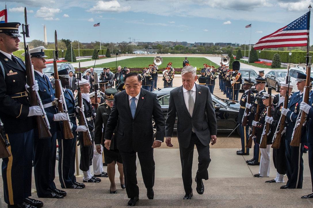 Defense Secretary James N. Mattis walks up steps with Thai Defense Minister Prawit Wongsuwan.