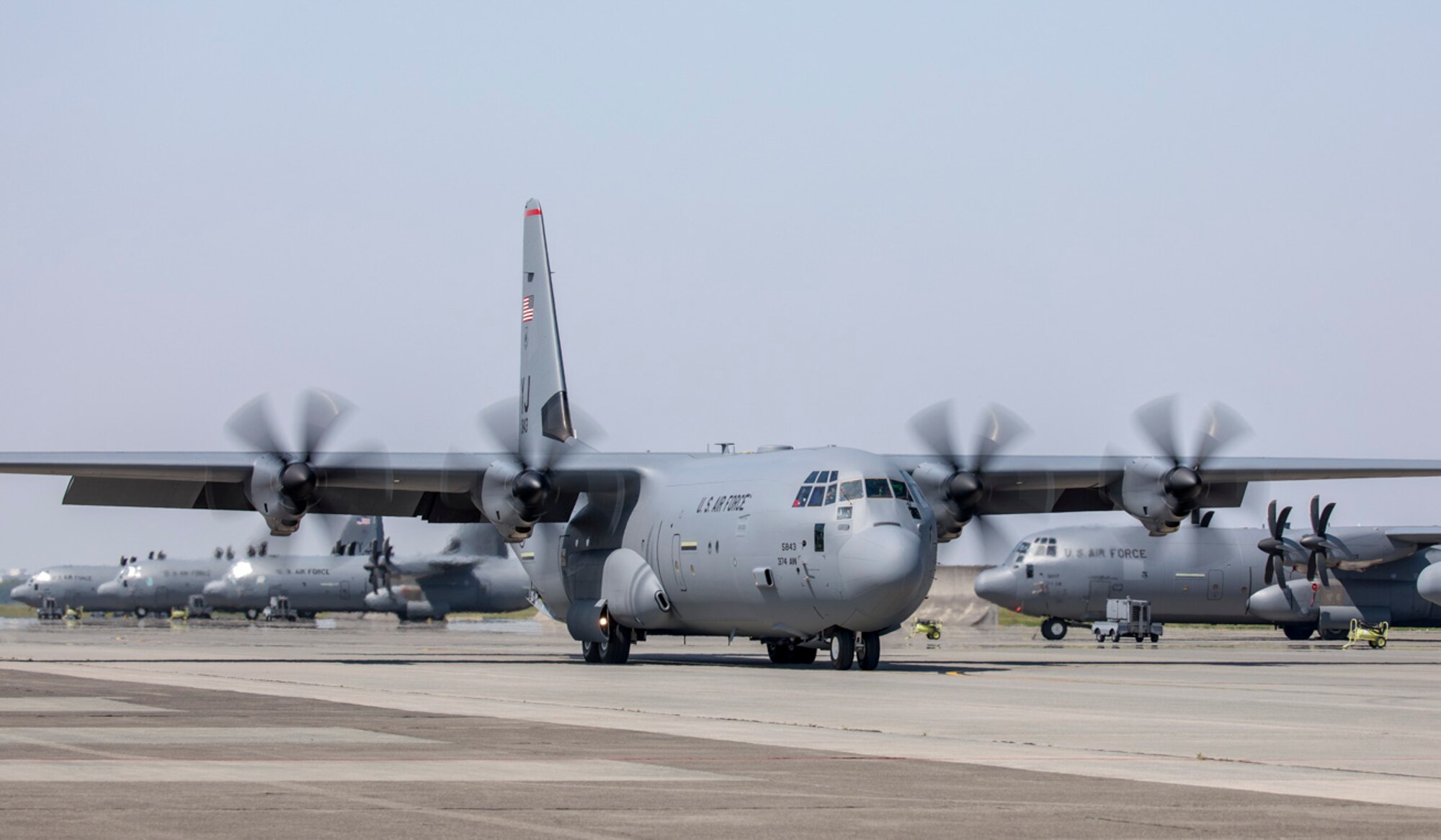 A C-130J Super Hercules taxis on the runway at Yokota Air Base, Japan