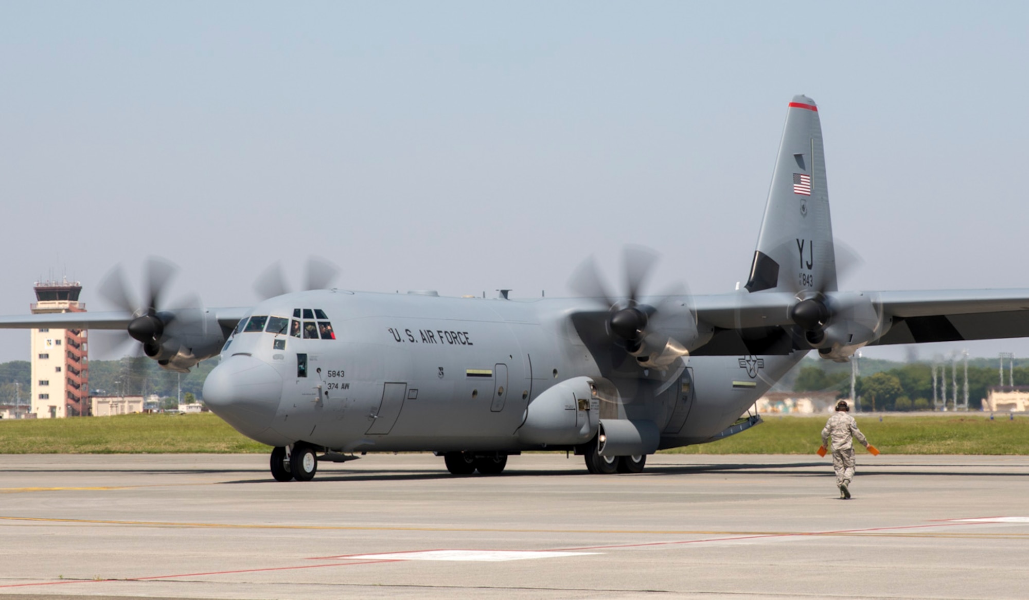 Master Sgt. Darl Parvin Jr., 374th Aircraft Maintenance Squadron section chief, marshals a C-130J Super Hercules at Yokota Air Base, Japan