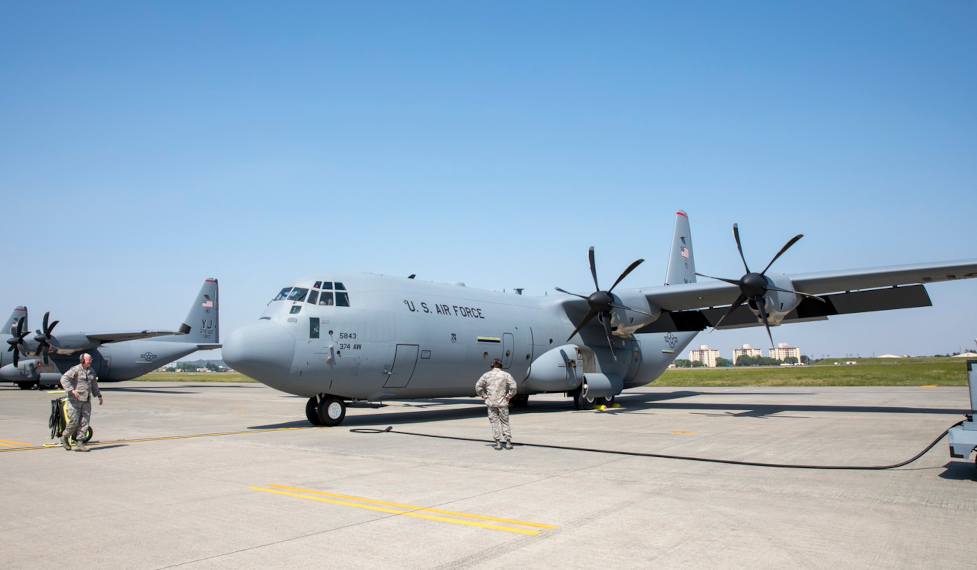 Maj. David Mueller, left, 374th Aircraft Maintenance Squadron commander, and Master Sgt. Darl Parvin Jr., 374th AMXS section chief, wait to connect an aircraft generator prior to starting a post-flight inspection at Yokota Air Base
