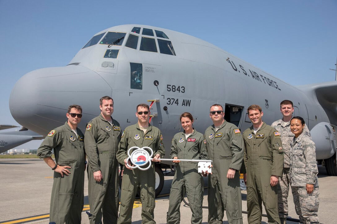 Members of the C-130J Super Hercules number 5843 delivery team pose for a photo at Yokota Air Base, Japan