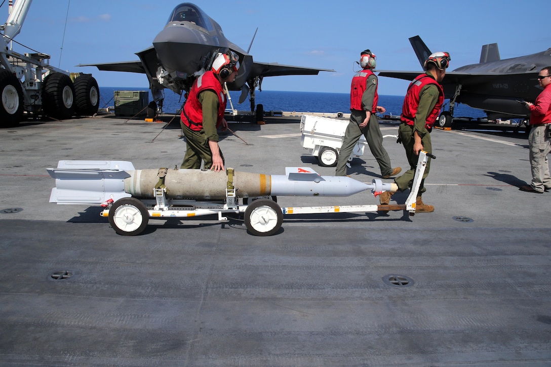 Marines transport a GBU-32 Paveway II laser-guided bomb.