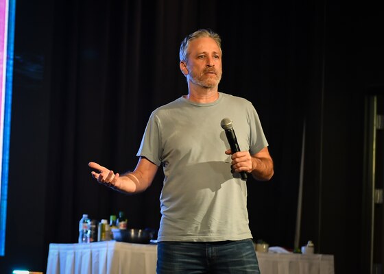 Comedian Jon Stewart opens an evening show with a comedy performance during a USO tour at Osan Air Base, Republic of Korea, April 23, 2018.