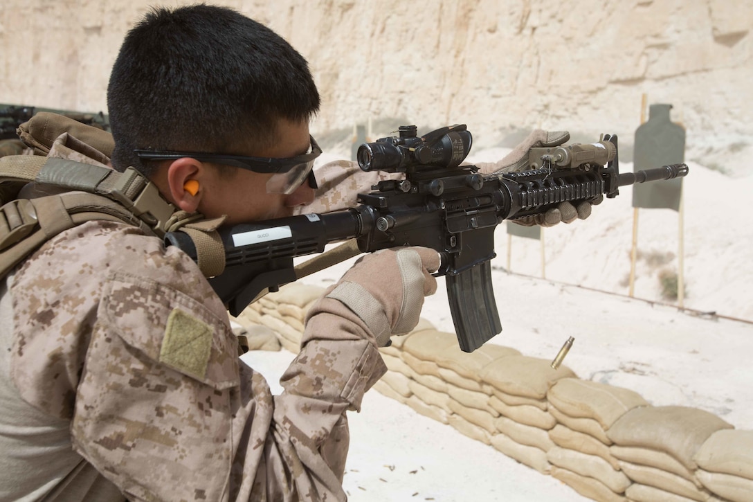 A U.S. Marine assigned to the Maritime Raid Force, 26th Marine Expeditionary Unit, fires an M4A1 carbine rifle during a 25 meter range as part of Eager Lion at the King Abdullah II Special Operations Training Center, Amman, Jordan, April 20, 2018. Eager Lion is a capstone training engagement that provides U.S. forces and the Jordan Armed Forces an opportunity to rehearse operating in a coalition environment and to pursue new ways to collectively address threats to regional security and improve overall maritime security.